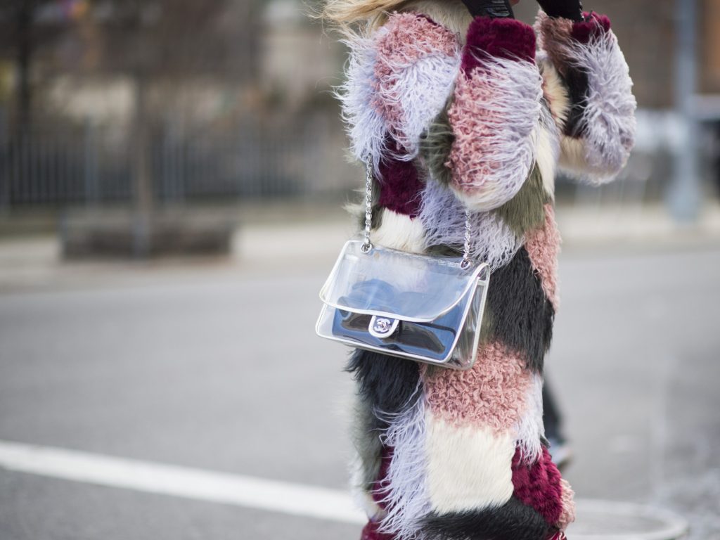 guest is wearing a colored mixed fur coat and a chanel transparent bag seen in the streets of Manhattan during New York Fashion Week: Women's Fall/Winter 2016