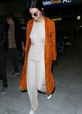 Kendall Jenner turned the Nice airport into her own personal runway upon her arrival in Cannes. The model rocked a neutral ensemble by Elle Sasson that she topped off with an orange Etro coat