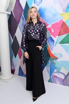 A-list attendee Natalie Dormer wore a deep purple heart-print blouse with modest wide-leg floor-skimming trousers to the Schiaparelli show