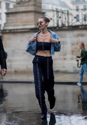 Bella Hadid turns heads in a scandalous strapless crop-top and matching roomy trousers underneath a classic denim jacket