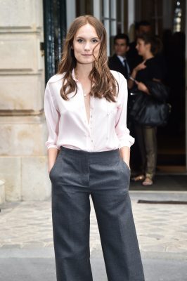 French actress Ana Girardot joins the front row at Dior Couture in a classic starched shirt and high-waisted wide-leg dark grey trousers
