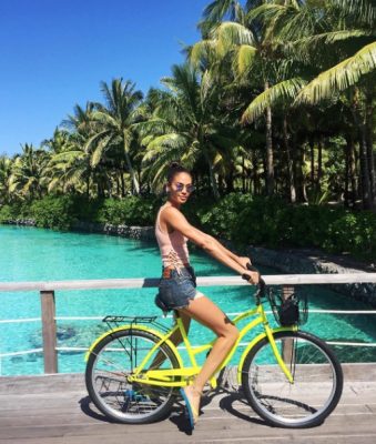 Joan Smalls navigates Bora Bora by bike. (Image courtesy of @joansmalls)
