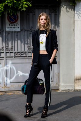 Model Ondria Hardin makes her way between shows in track-style trousers.