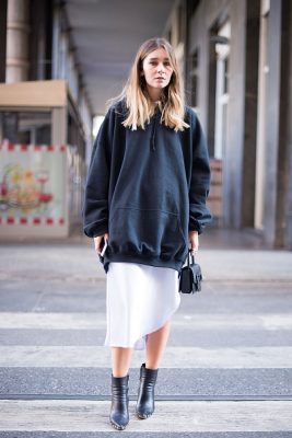 Chiara Capitani's black hoodie adds a sportswear edge to her white skirt.