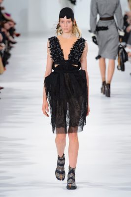 Maison Margiela's delicate black lace dress is ideal for a summer soirée.