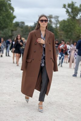 Giorgia Tordini drapes a masculine coat over a pair of leather trousers and a shirt.