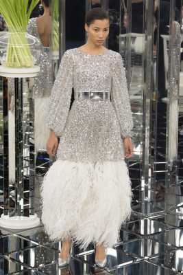 Chanel: The collection spoke out with 1920s glamour. Beaded, dropped waists were adorned with layers of ice white plumes that recalled pre-Depression opulence
