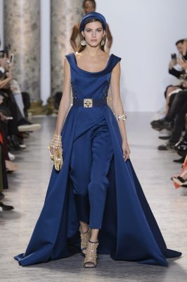 Elie Saab: Omar Sharif and Oriental gold made up the inspirational material for this collection of elaborate gowns.  Recalling an era of retro glamour pastel blues made us think of Jackie Kennedy while caped midnight blue jumpsuits tricked the eye and offered an alternate option for red carpet glamour