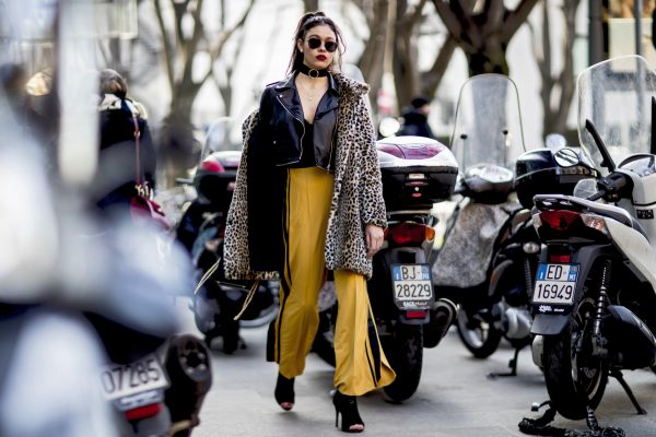 Mustard yellow flared trousers and a leopard print coat make a bold statement