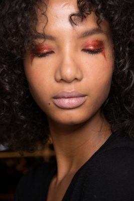 The Hue: Metallic eyeshadow moved away from traditional gold and silver at Christian Siriano with sparkling shades of burnished amber dusted over eyelids.