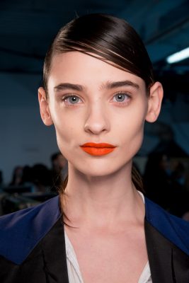 Eudon Choi: Tangerine statement lips illuminated the navy, teals and moss greens of the collection