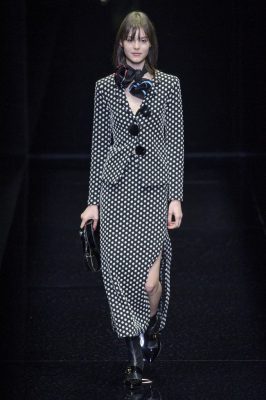 Emporio Armani: Understated, yet bold, prints in classic shades (mostly black and white) strutted down the runway. Polka dot patterned coats, fur jackets and plastic skirts injected a dose of urban grunge into an otherwise sophisticated collection. Red velvet hems added excitement to modest black ensembles, as did small leather bags, gilded sneakers and ankle boots.