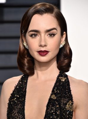 Lily Collins. Thought it might seem like your ordinary cat-eye liner from afar? Makeup artist Fiona Stiles actually created something quite unique in the form of negative space between the liner’s tip. Using Lancôme products, Collins’ deep berry lips created a vision unlike any other from the night.