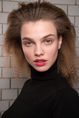 Ports: Crimps stayed with the opulent Eighties while toned-down makeup let bitten lips do the talking