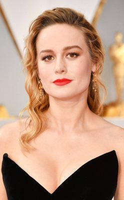 Brie Larson. Opting for a less conventional approach, the actress accentuated her lashes and brought drama to her ensemble via a bold orange shade of lipstick, tanned contouring and spiral side swept curls