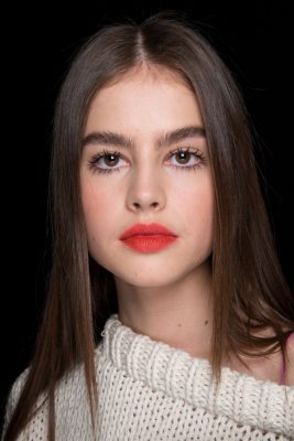 Topshop Unique: Sleek straight hair parted in the centre while bushy brows and orange-tinted lips were a refreshing update from the season's usual darker shades