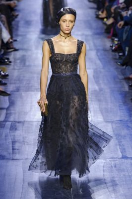 Beautiful gowns in midnight blue were embroidered with lacy black flowers, swishing full skirts created a sense of movement.