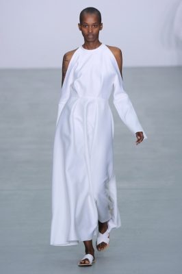 Sid Neigum. White can be as slimming as its symbolic counterpart; black. It’s all about the sleeves. Look to bell sleeved dresses paired with a hem that falls just above the ankle along with cut outs at the shoulder bone. This peek-a-boo of skin adds a touch of whimsy to a more formal silhouette