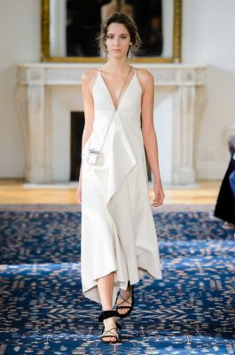 Valentino.  Whether meeting friends for a morning coffee or visiting the farmer’s market in between running errands, a white dress that is cut on the bias possesses a certain sense of movement. For day to nightwear neutrality look to dresses with handkerchief hems and pair with decadent messenger bags.