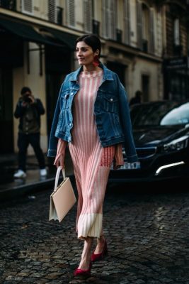 Street style. Most Parisians kept it elegantly light for day six of Paris Fashion Week with ensembles that showcased one or two textiles devoid of dramatic contrast. Here, the trending denim jacket is paired with a light-knitted dress and velveteen heels.