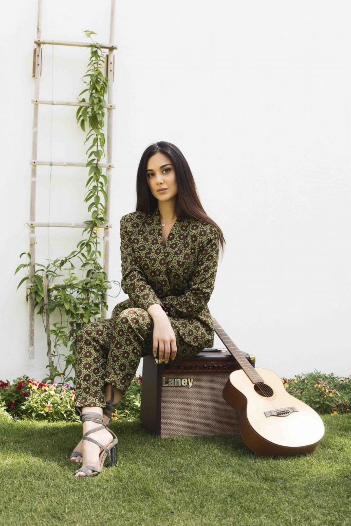 Layla Kardan photographed for MOJEH 46 at Desert Palm Per Aquum wearing Arwa Al Banawi trouser suit and Cartier necklace