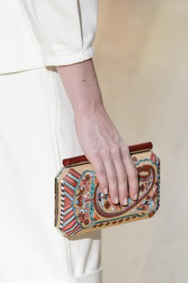 Oscar de la Renta. Purses that display intricate beading or handwoven textiles across the exterior instantly captivate onlookers. Pair beaded purses against the free flowing flare of an A-line skirt to exude femininity