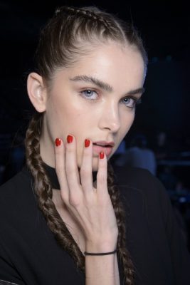 Emporio Armani | Meticulously arranged extra-long twin braids embrace Armani’s not-so-newfound love for athleisure. To achieve this bold look, weave waist-length extensions into plaits and complement with a fun, pillar box-red polish.
