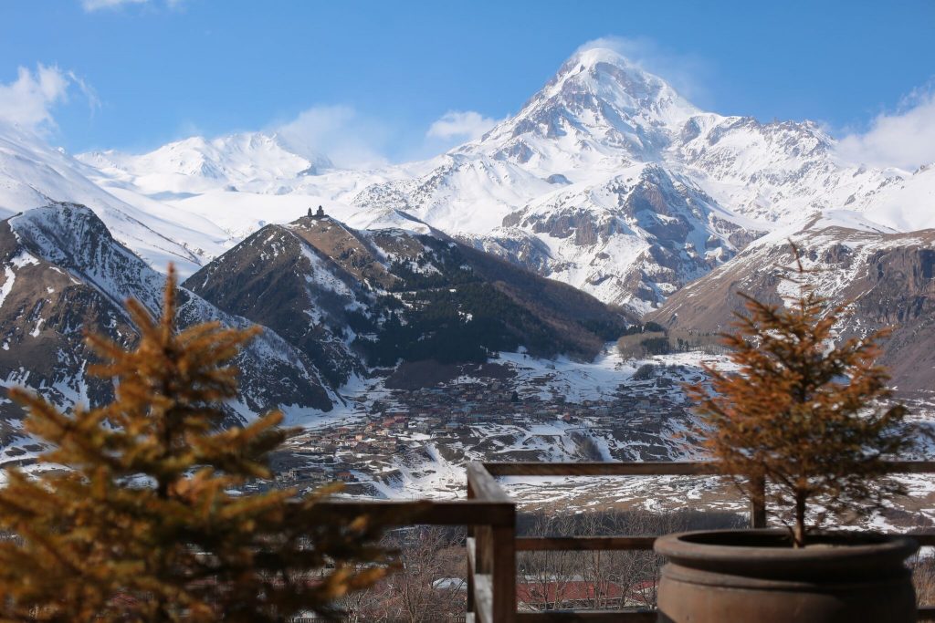 Head to the lush mountain range of Kazbegi and you’ll trudge through four seasons in one day. The view from Rooms Hotel Kazbegi