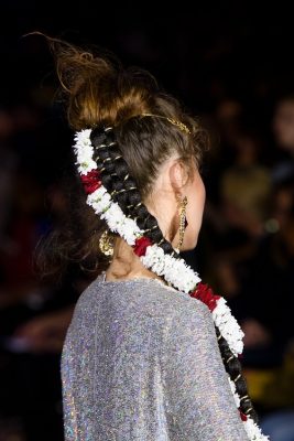 Ashish | Vibrant, funky-coloured ribbons and floral embellishments are worn on Ashish’s runway and used to decorate super-chunky pony plaits. Blessed with thick tresses? Separate a high pony into up to three separate plaits for added drama.