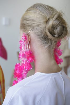 Delpozo | This youthful hairstyle works on all lengths of hair – pull locks back into a pony and roughly part hair into a soft, wispy braid. Twirl into a loose-fitting bun or knot and draw attention with an over-sized, colourful pair of statement earrings.