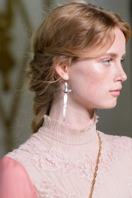 Valentino | The luxury maison gracefully brings 19th Century romanticism to the 21st Century with pretty, extra-long and loose plaits, that are fastened low towards the nape of the neck. Perfect for those with light-weight and wavy hair, wear with a dusting of sun-kissed blush.