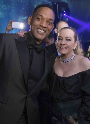 Actor Will Smith poses for a picture with Chopard’s co-president Caroline Scheufele in a strikingly handsome jet-black tailored suit.