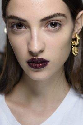 DKNY: For all out glamour go for a shimmery deep red lipstick, use a gold lip liner to accentuate the cupid's bow and centre of the lip. Keep eye makeup to a minimum in order to ensure this is the focal point of your look.