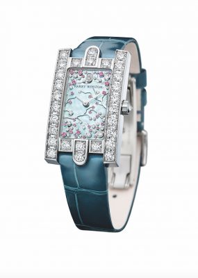 Harry Winston’s Avenue Classic Cherry Blossom wristwatch boasts an iridescent backdrop to a chaotic flurry of 39 white diamonds and 29 pink sapphires that represent the flower and petals that adorn a cherry blossom tree. The rectangular and ultra-feminine tableau is framed by an 18-karat white gold case, whose architecture echoes the stately stone facade of Winston’s historic Fifth Avenue Salon in New York, as well as the three arches surrounding the entrance.
