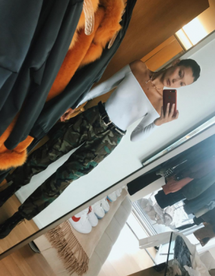 Bella Hadid’s high-waisted camo trousers and slick white off-shoulder top is everything street style photographers dream of. For those who aren’t too fond of printed trousers a silk version by Céline can work just as well.