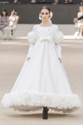 The Bride: Well-known for the unbelievably creative transformations of show spaces, Chanel's consistent runway highlight is its ivory-drenched bride. For autumn/winter17, Camille Hurel was handpicked to wear Karl Lagerfeld's most recent wedding gown. Black booties and a vintage Victorian-esque hair piece elevated the look from pretty to glamorous.