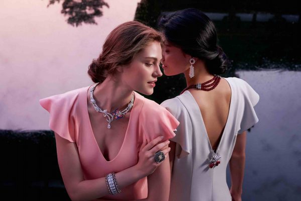 Two models wear the bracelet entitled Dentelle Secrete in white gold, with diamonds, rubies, onyx and white mother-of-pearl, alongside the Labyrinthe Ring with a cushion-cut Fancy Intense Yellow diamond of 13.01 carats
