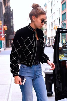 Gigi Hadid steps out in a messy midi bun. Create volume at the crown to avoid too much structure around the face.