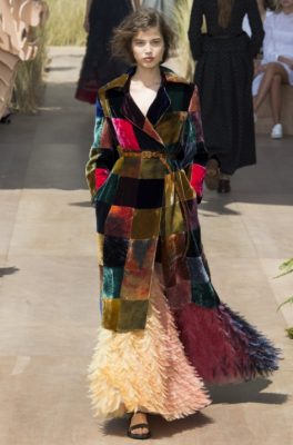 Patchwork detailing in rich jewel tones brought a pared back element to frothy gowns and feathered skirts.