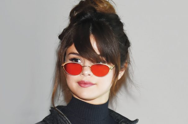Selena's glasses with red tinted lenses tap into Sixties nostalgia.