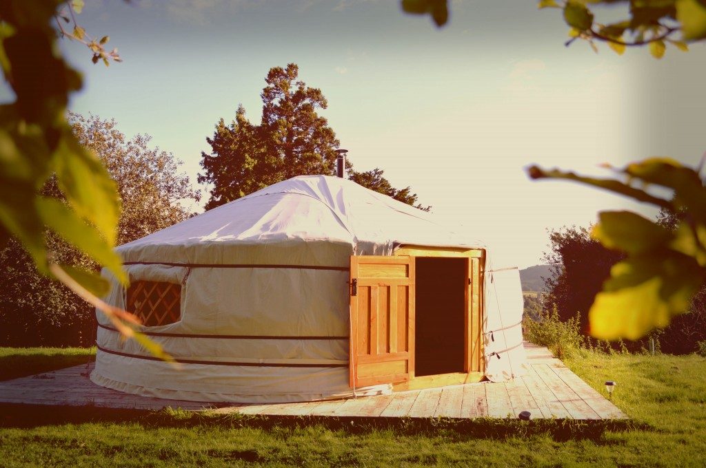 A traditional yurt is a portable, round tent covered with skins and used as a dwelling by nomads