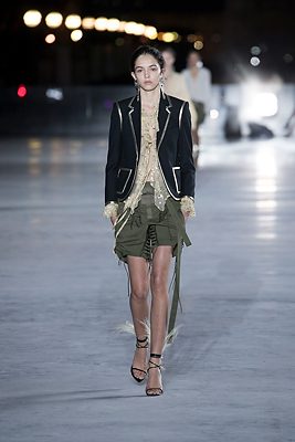 The Details: Corset fastenings and hanging laces added elements of interest to safari-style olive-green shorts while gold piping completed structured blazers and air-light cream, feathers elevated cross-tie sandals.