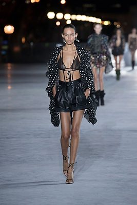 The Cover-up: Shoulders slipped into lightly ruffled, sparkling, sheer jackets that slinked down the runway.
