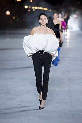 The Silhouette: Ballooned proportions are balanced by high-shine cigarette pants on the bottom half. A monochrome palette keeps the form the main focus.
