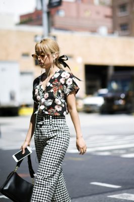 Eschew the norm by pairing gingham trousers with a floral shirt or top. Black accessories will help to keep the look grounded.