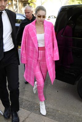 Spotted heading to the Fendi show, Gigi Hadid rocked a Seventies-inspired aesthetic, which is epitomised here with rectangular yellow-tinted sunnies. Her matching Barbie-pink trousers and a trench coat look incredible with Stuart Weitzman’s white boots.