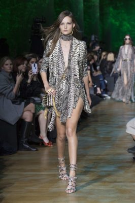Elie Saab: Elie Saab’s Amazonian warriors marched the runway in an array of exotic skins and lush foliage prints. Glamourous kaftans, party dresses and evening gowns were all enhanced by the jungle themed interiors.