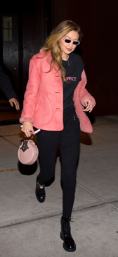Gigi Hadid wore the leather trim shearling oversized jacket in copper pink in New York