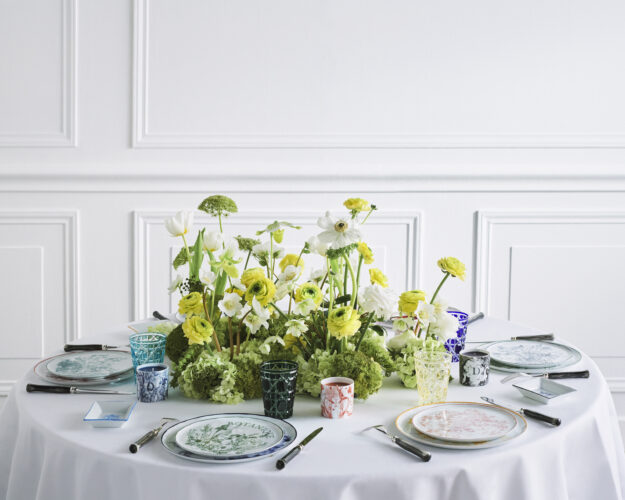 Table with ABCDior homeware and floral centrepiece