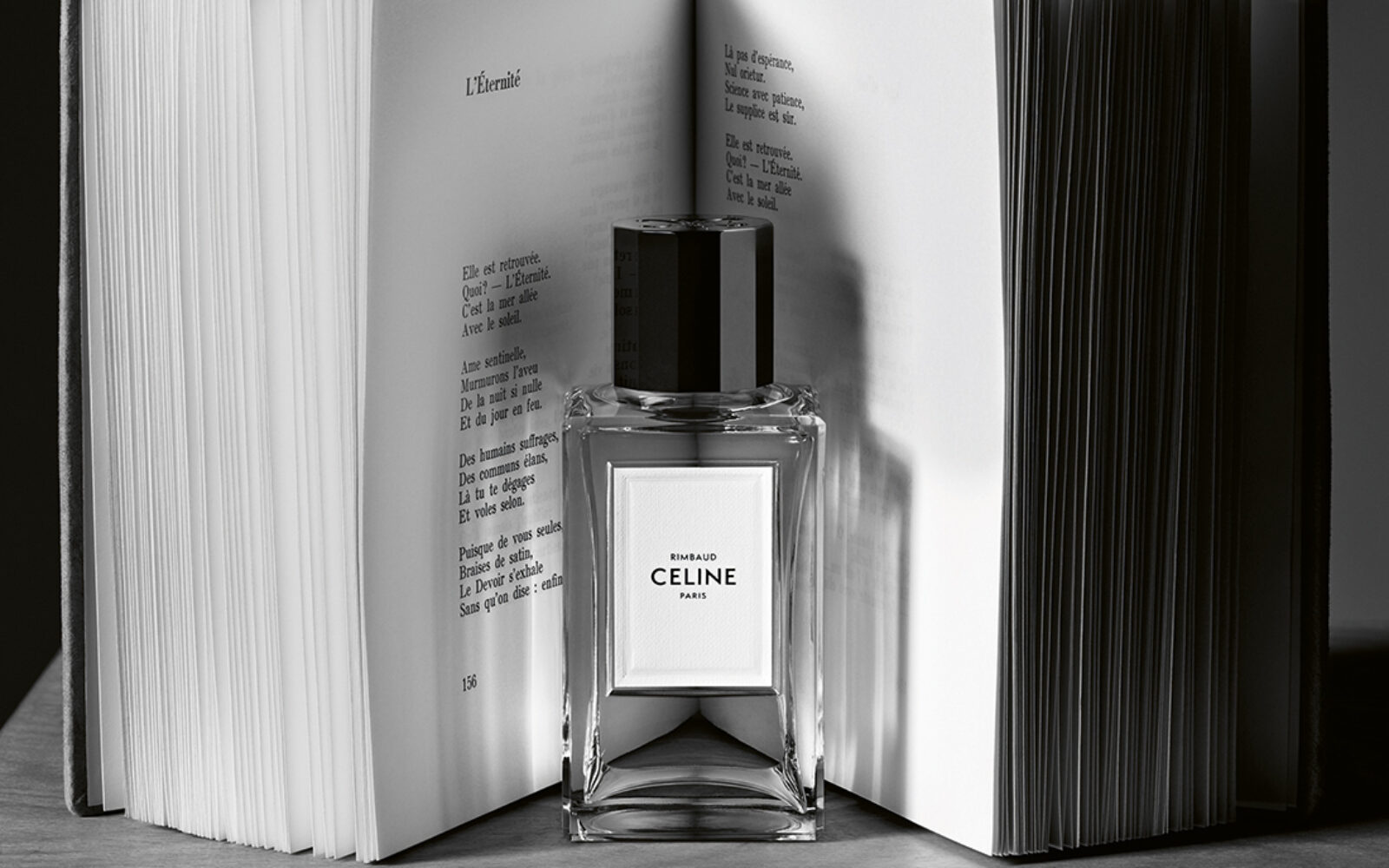 Bottle of Celine Rimbaud fragrance in front of an open book